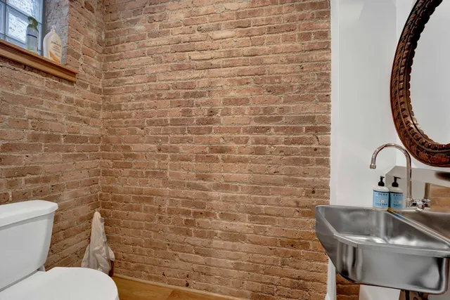 a bathroom with a toilet sink and mirror
