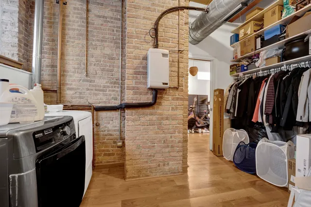 a view of walk in closet with clothes and shoes