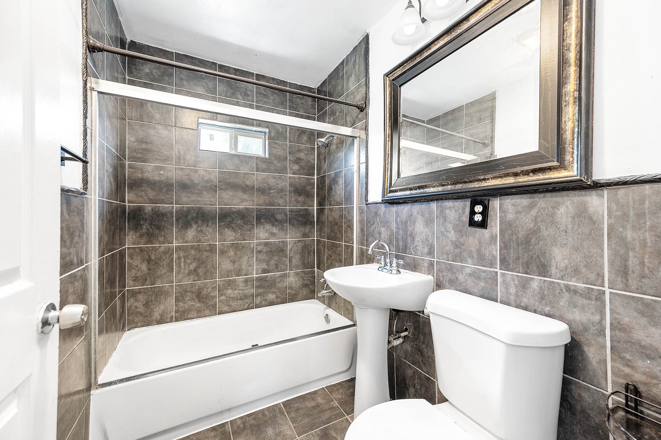 3910 Luca Street, Unit R1 Houston, TX 77021 - Photo 9 of 31 a bathroom with a toilet a sink and a glass door shower