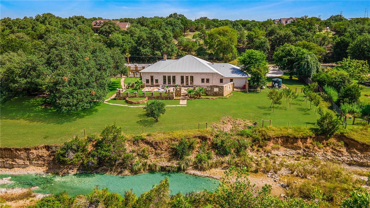 a house with green field in front of it