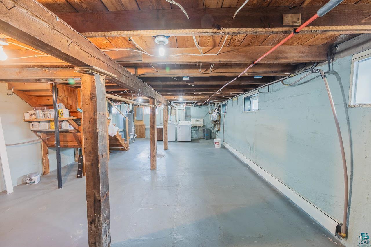508 10th Street South Virginia, MN 55792 - Photo 29 of 43 Unfinished basement featuring exposed wood beams, concrete flooring, and multiple windows