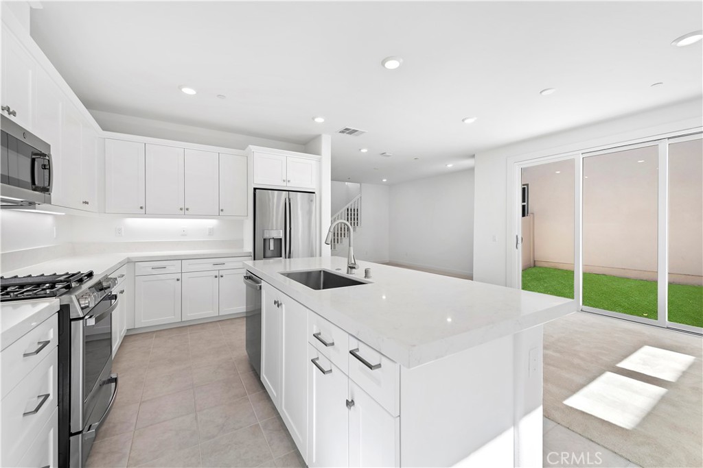 214 Denali Lake Forest, CA 92630 - Photo 4 of 11 a kitchen with white cabinets and white appliances