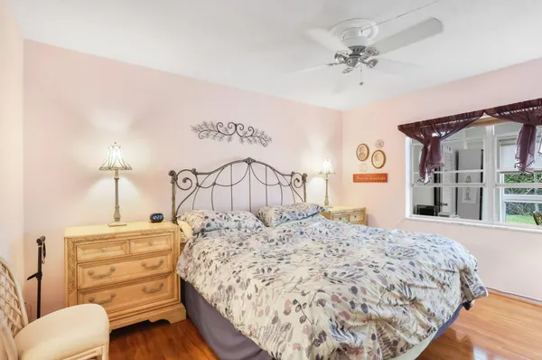 a bedroom with a bed a chandelier and dresser