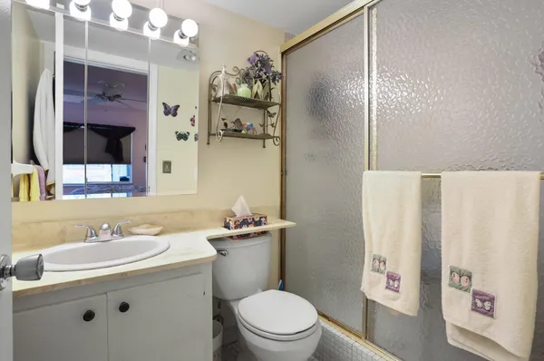 a bathroom with a sink a toilet and shower curtain