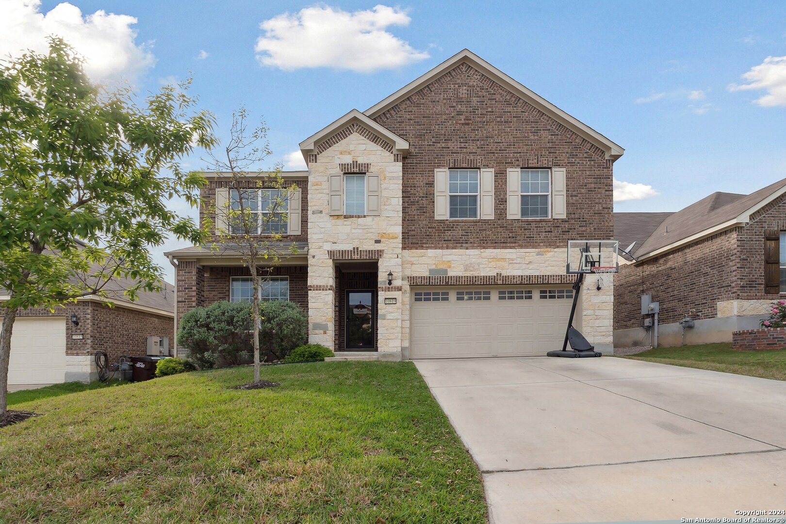 a front view of a house with a yard and garage