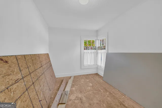 a view of room with window and hardwood floor