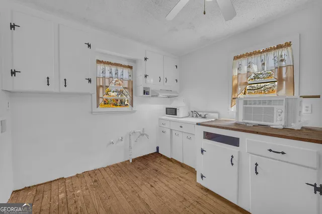 a view of kitchen with cabinets and wooden floor