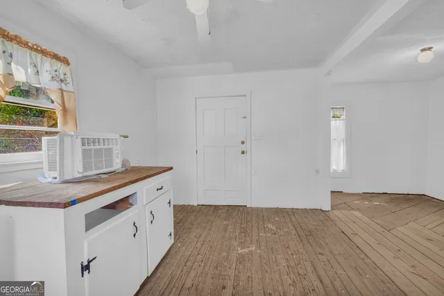 a kitchen with a wooden floor and a window