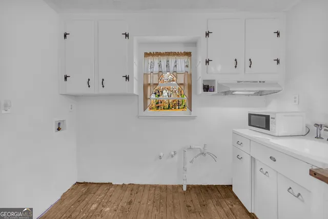 a view of cabinets and wooden floor