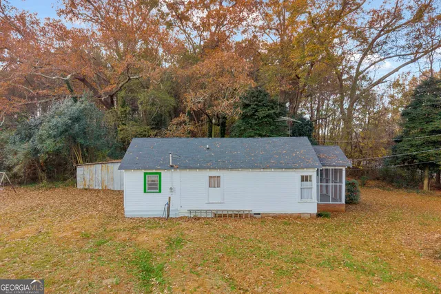 a front view of house with yard and trees