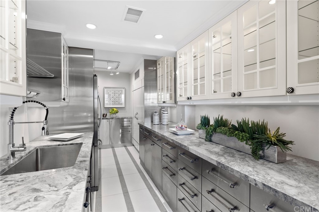 1991 Ocean Way Laguna Beach, CA 92651 - Photo 30 of 52 a kitchen with stainless steel appliances kitchen island granite countertop a sink a stove and cabinets