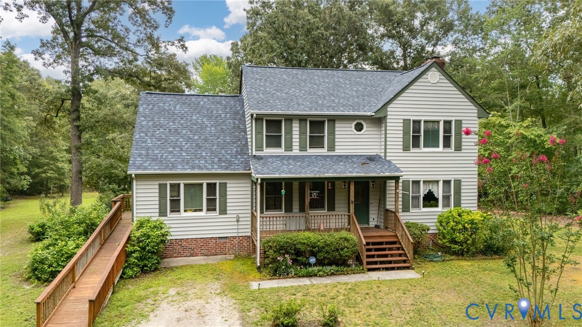 Two-story residence featuring light gray siding wi