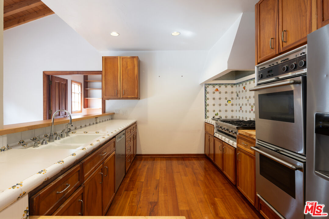 200 Mabery Road Santa Monica, CA 90402 - Photo 4 of 18 a kitchen with granite countertop a stove top oven and sink