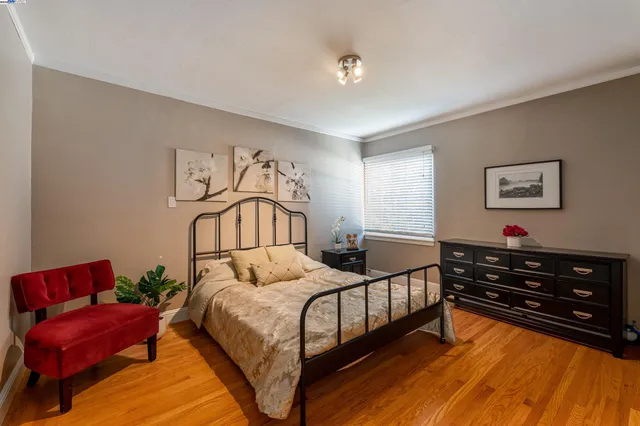 a bedroom with a bed a couch and dresser