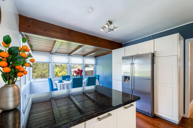 a kitchen with stainless steel appliances granite countertop a sink window and a refrigerator