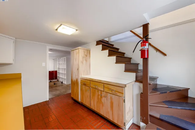 a view of a livingroom with wooden floor and stairs