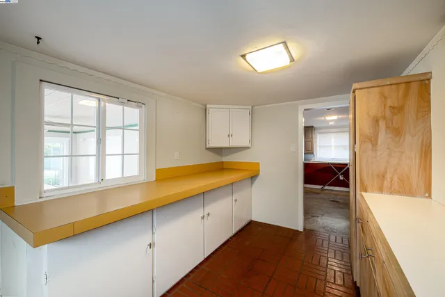 a view of a kitchen with a sink and cabinets