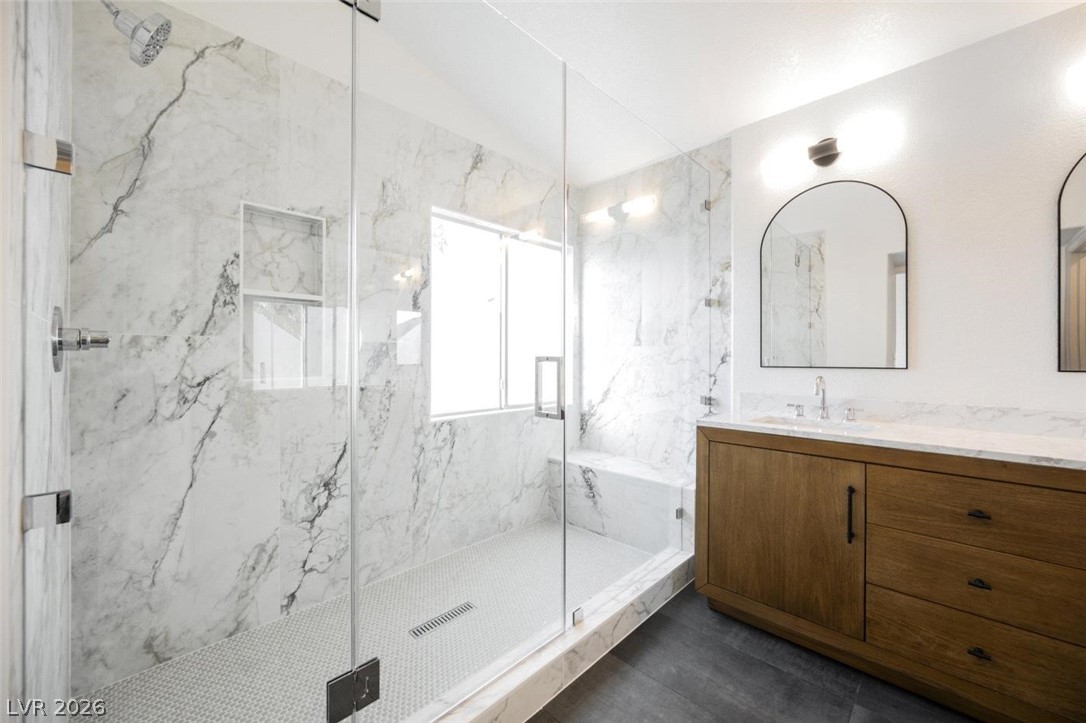 2651 Ridgewater Circle Henderson, NV 89074 - Photo 14 of 27 This modern bathroom offers a spacious walk-in shower and elegant vanity.