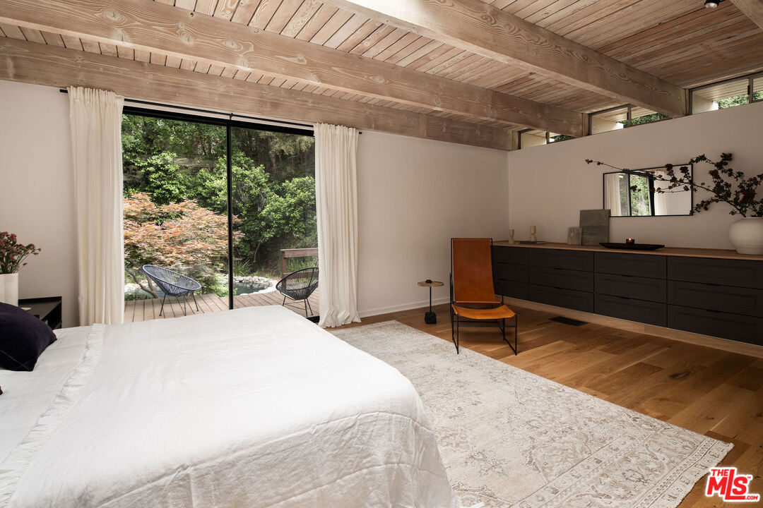 7330 Pyramid Drive Los Angeles, CA 90068 - Photo 14 of 28 a bedroom with a bed and large windows
