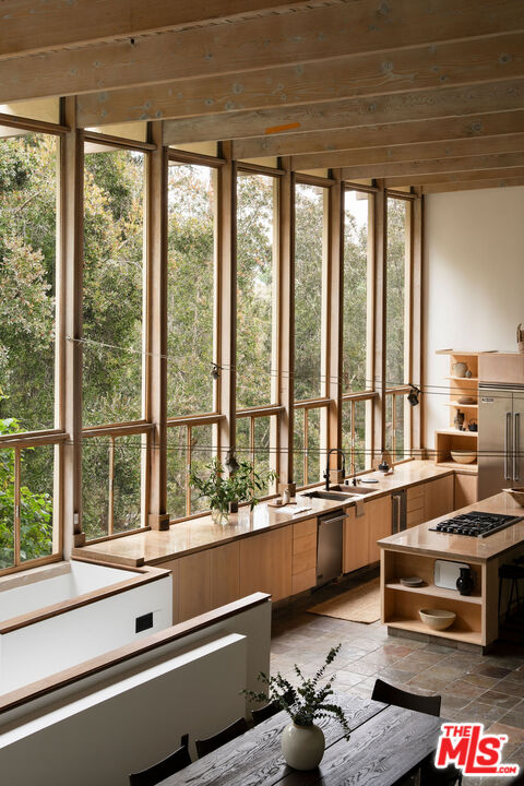 7330 Pyramid Drive Los Angeles, CA 90068 - Photo 9 of 28 a room with large windows and a table