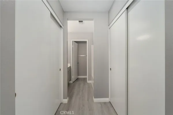 a view of a hallway with wooden floor