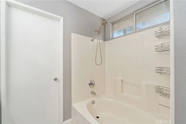 a white bath tub with a shower