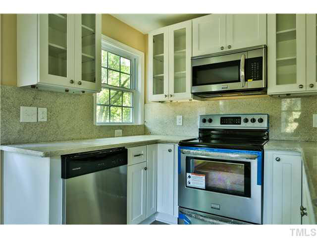 711 Tyler Road Raleigh, NC 27604 - Photo 11 of 24 a kitchen with stainless steel appliances a stove microwave and cabinets