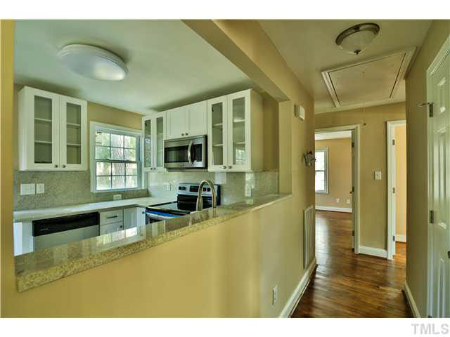 711 Tyler Road Raleigh, NC 27604 - Photo 12 of 24 a bathroom with a sink a bathtub and next to a window