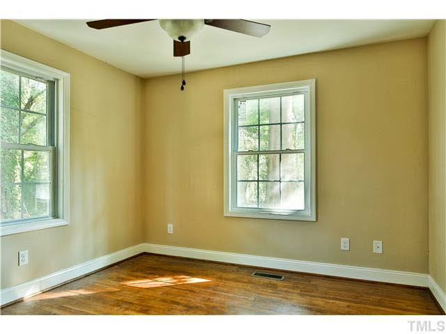 711 Tyler Road Raleigh, NC 27604 - Photo 13 of 24 a view of an empty room with wooden floor and a window