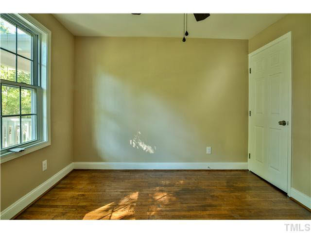 711 Tyler Road Raleigh, NC 27604 - Photo 16 of 24 a view of an empty room with wooden floor and a window