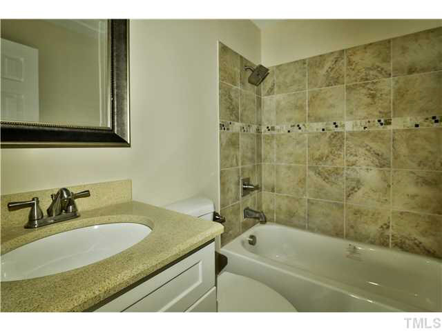 711 Tyler Road Raleigh, NC 27604 - Photo 21 of 24 a bathroom with a sink and a mirror