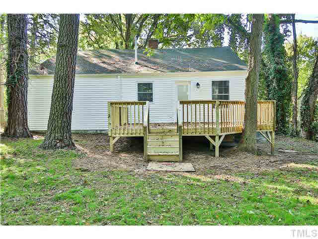 711 Tyler Road Raleigh, NC 27604 - Photo 22 of 24 a view of a house with backyard and a tree