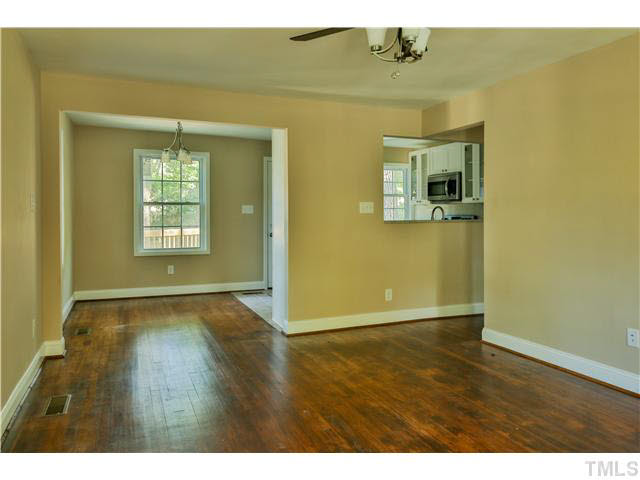 711 Tyler Road Raleigh, NC 27604 - Photo 5 of 24 a view of an empty room with wooden floor and a window