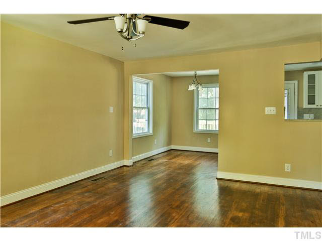 711 Tyler Road Raleigh, NC 27604 - Photo 6 of 24 a view of an empty room with window and wooden floor