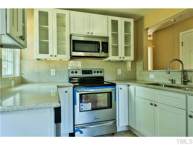 711 Tyler Road Raleigh, NC 27604 - Photo 10 of 24 a kitchen with stainless steel appliances granite countertop a sink stove and microwave