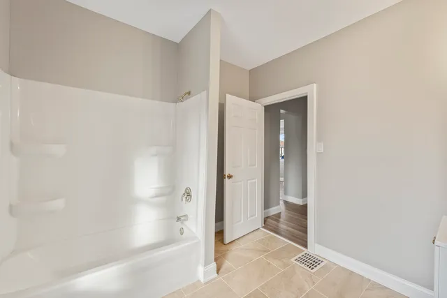 a bathroom with a bathtub and shower