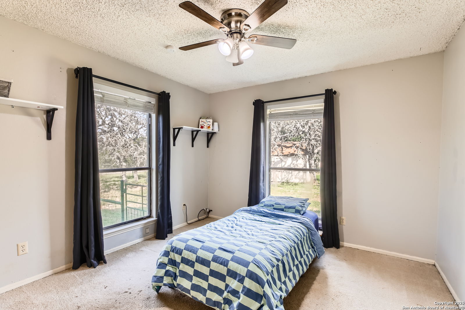 1608 Kings Ranch Road Bandera, TX 78003 - Photo 11 of 14 a bedroom with a large bed and a window