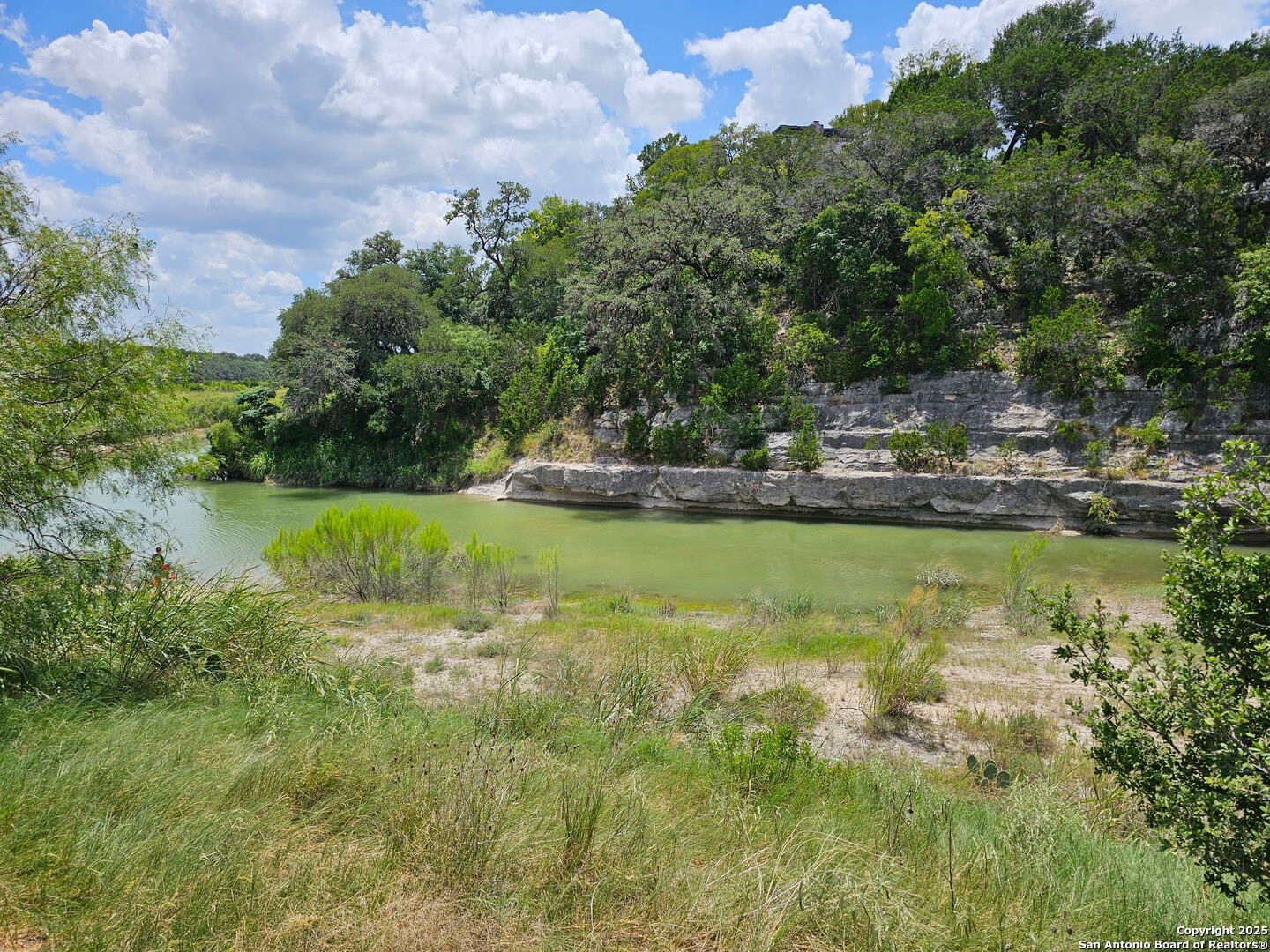 1608 Kings Ranch Road Bandera, TX 78003 - Photo 3 of 14 a view of a lake with houses in the background