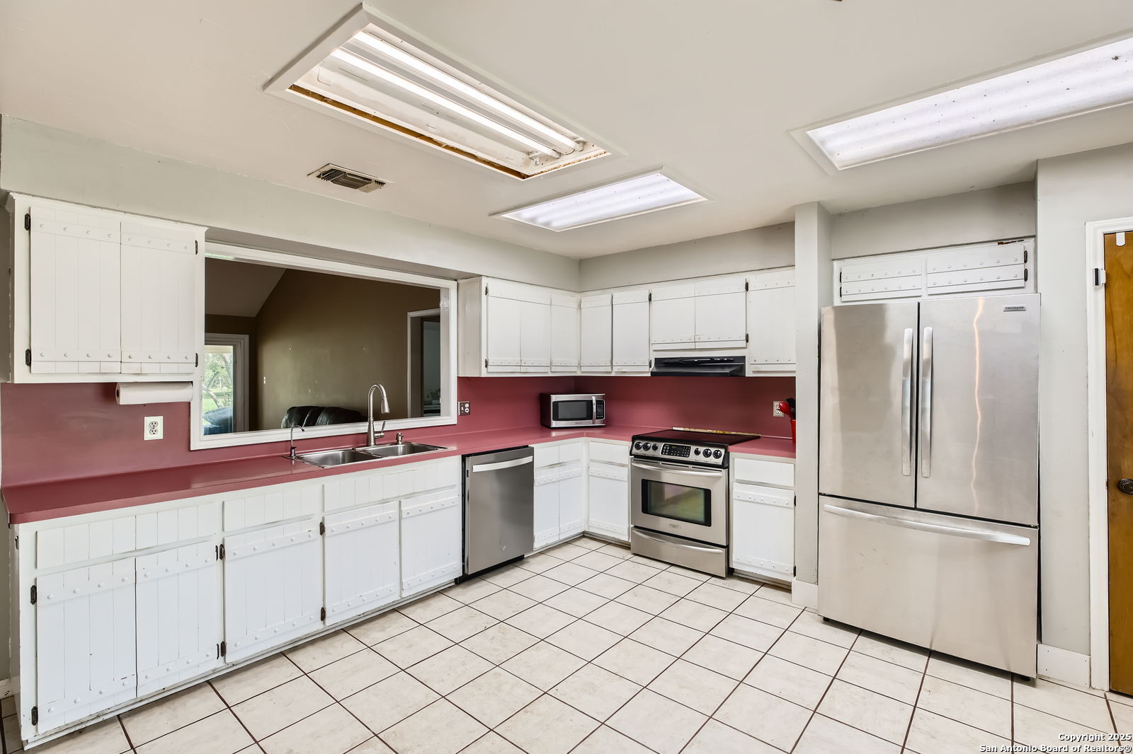 1608 Kings Ranch Road Bandera, TX 78003 - Photo 8 of 14 a kitchen with white cabinets appliances and sink