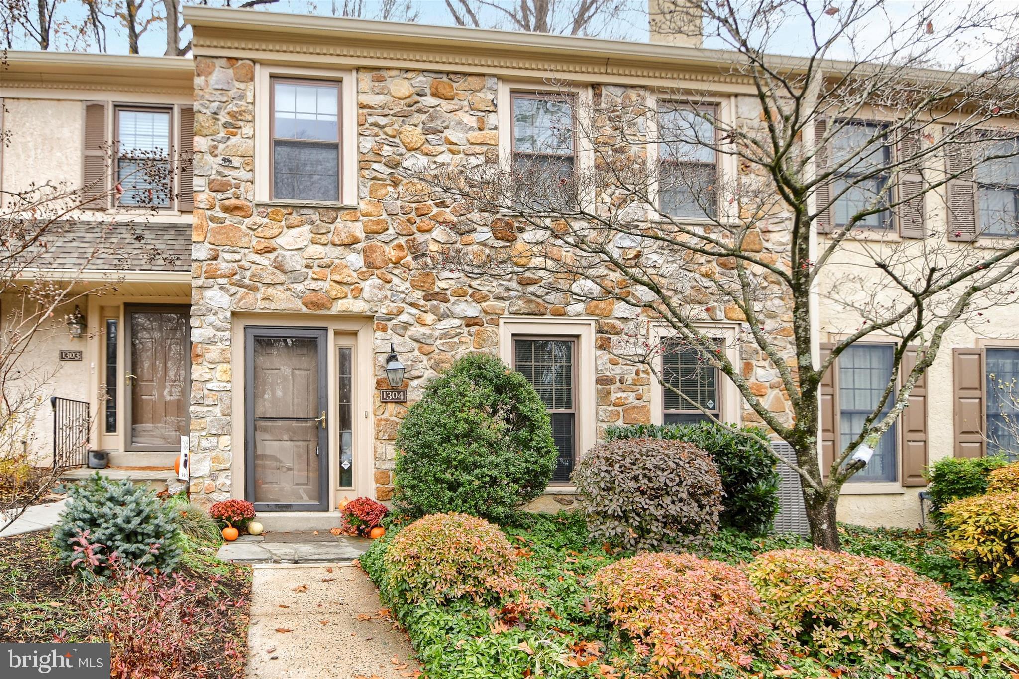 front view of a brick house with a large windows