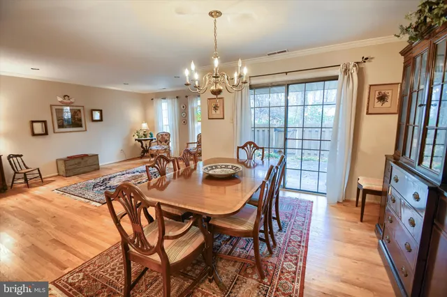 a view of a dining room with furniture and a chandelier