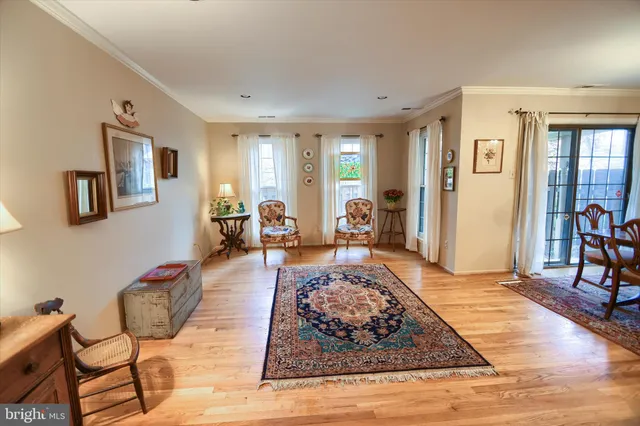 a living room with furniture rug and wooden floor