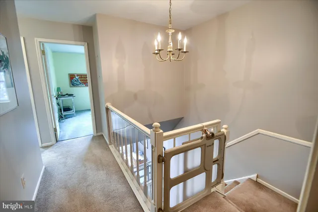 a view of a livingroom with wooden floor and stairs