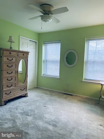 a view of an empty room with a fireplace and a window