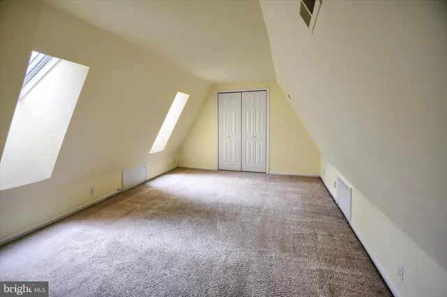 an empty room with a empty space and windows