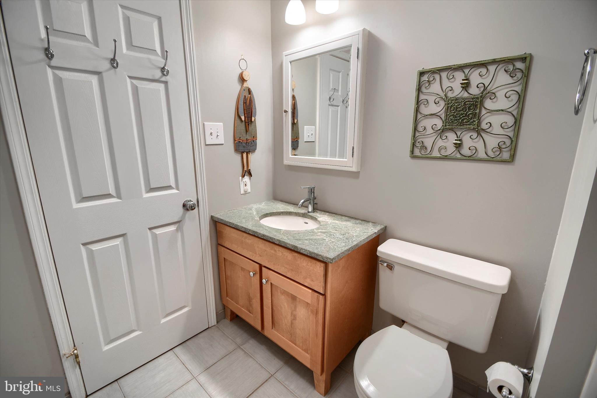 1304 Weatherstone Drive, Unit 1304 Paoli, PA 19301 - Photo 24 of 35 a bathroom with a toilet a sink a vanity and mirror