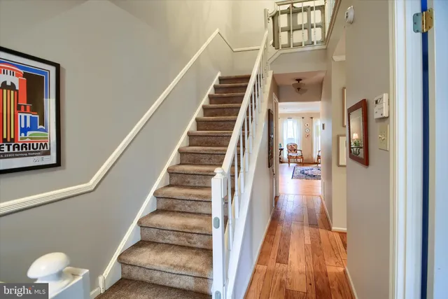a view of entryway and hall with wooden floor