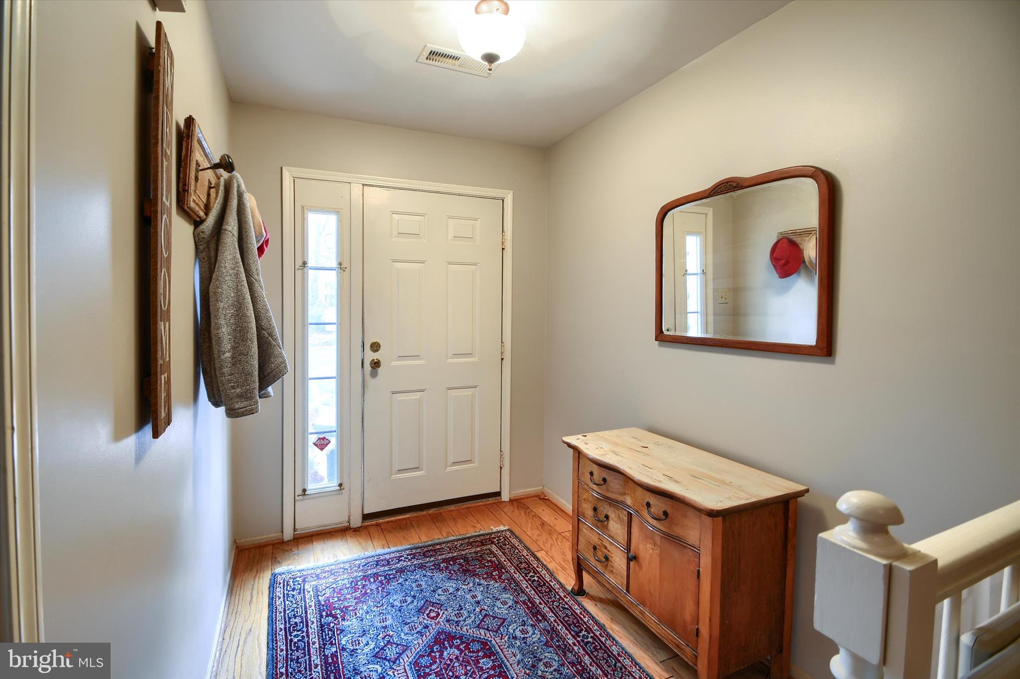 1304 Weatherstone Drive, Unit 1304 Paoli, PA 19301 - Photo 4 of 35 a hallway with front door wooden floor and closet