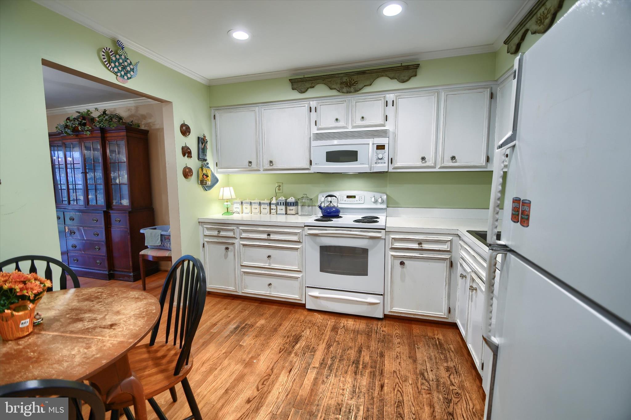 1304 Weatherstone Drive, Unit 1304 Paoli, PA 19301 - Photo 10 of 35 a kitchen with stainless steel appliances a stove a sink cabinets and a wooden floor
