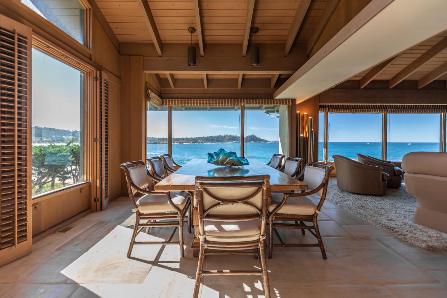 a dining room with furniture and a floor to ceiling window